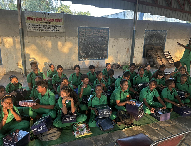 Children in a classroom raising hands